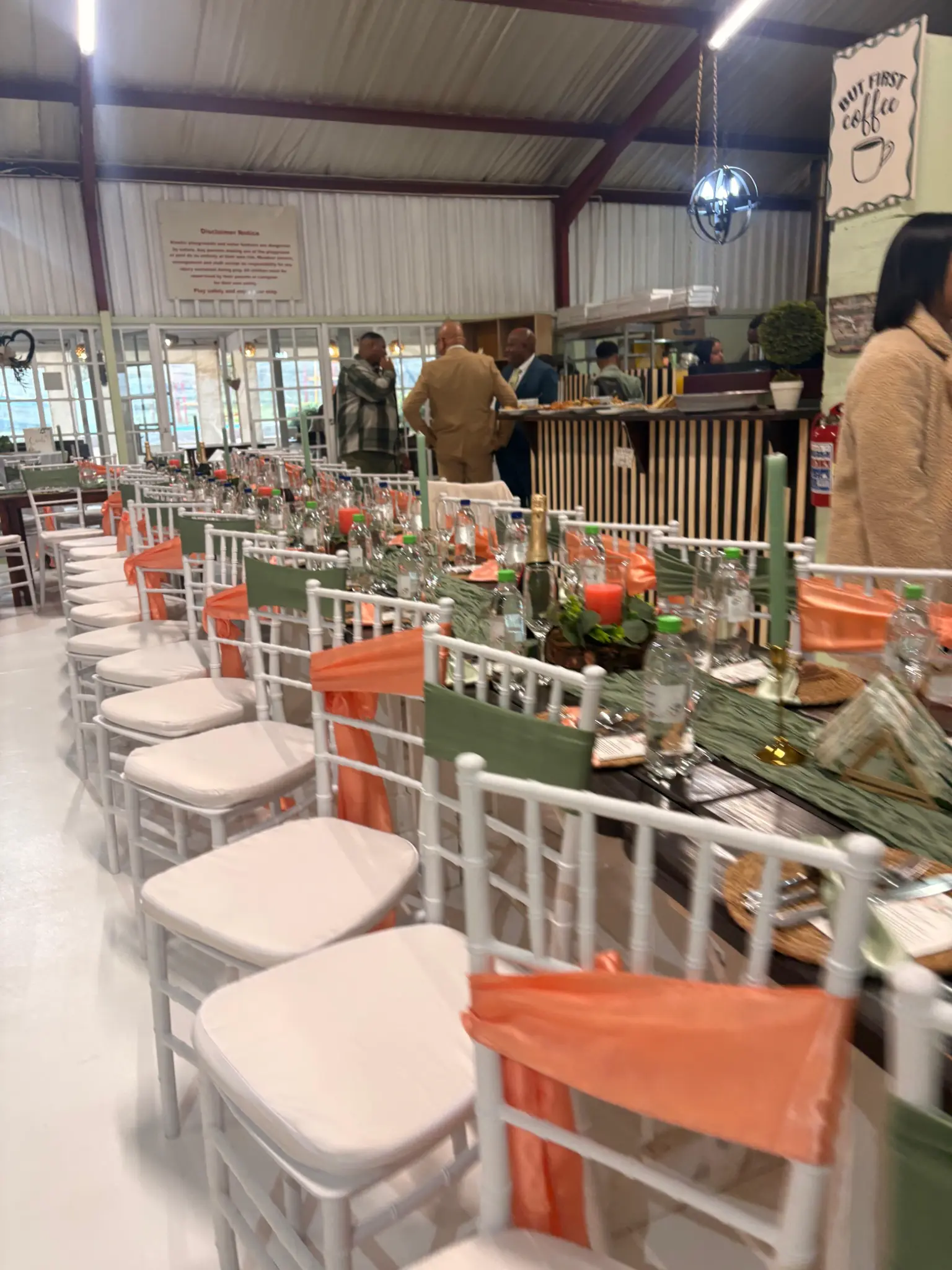 Wedding reception setup with dressed tables and white chairs at Olive & Vine