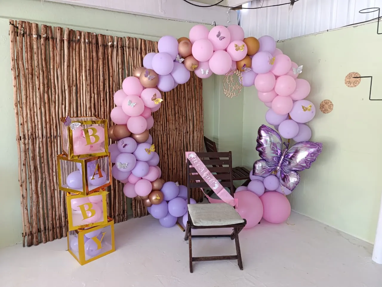 Baby shower balloon arch and decorated seating area at Olive & Vine