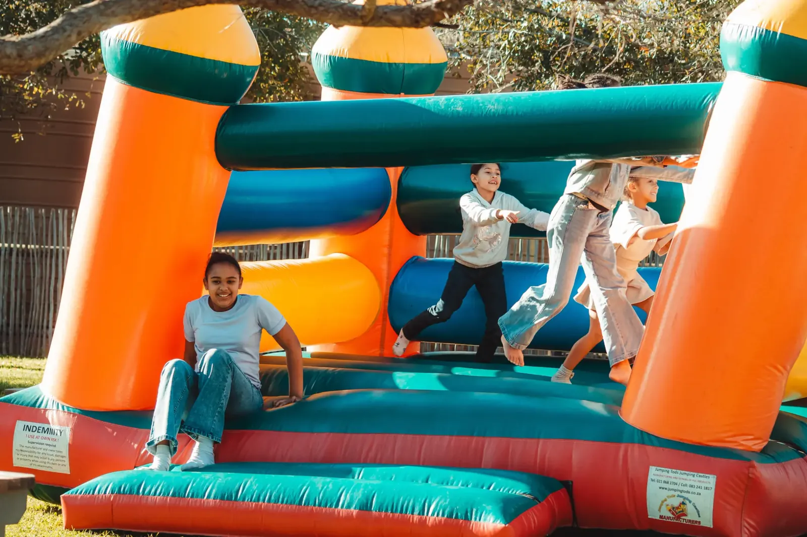 Children enjoying a colourful outdoor inflatable play structure