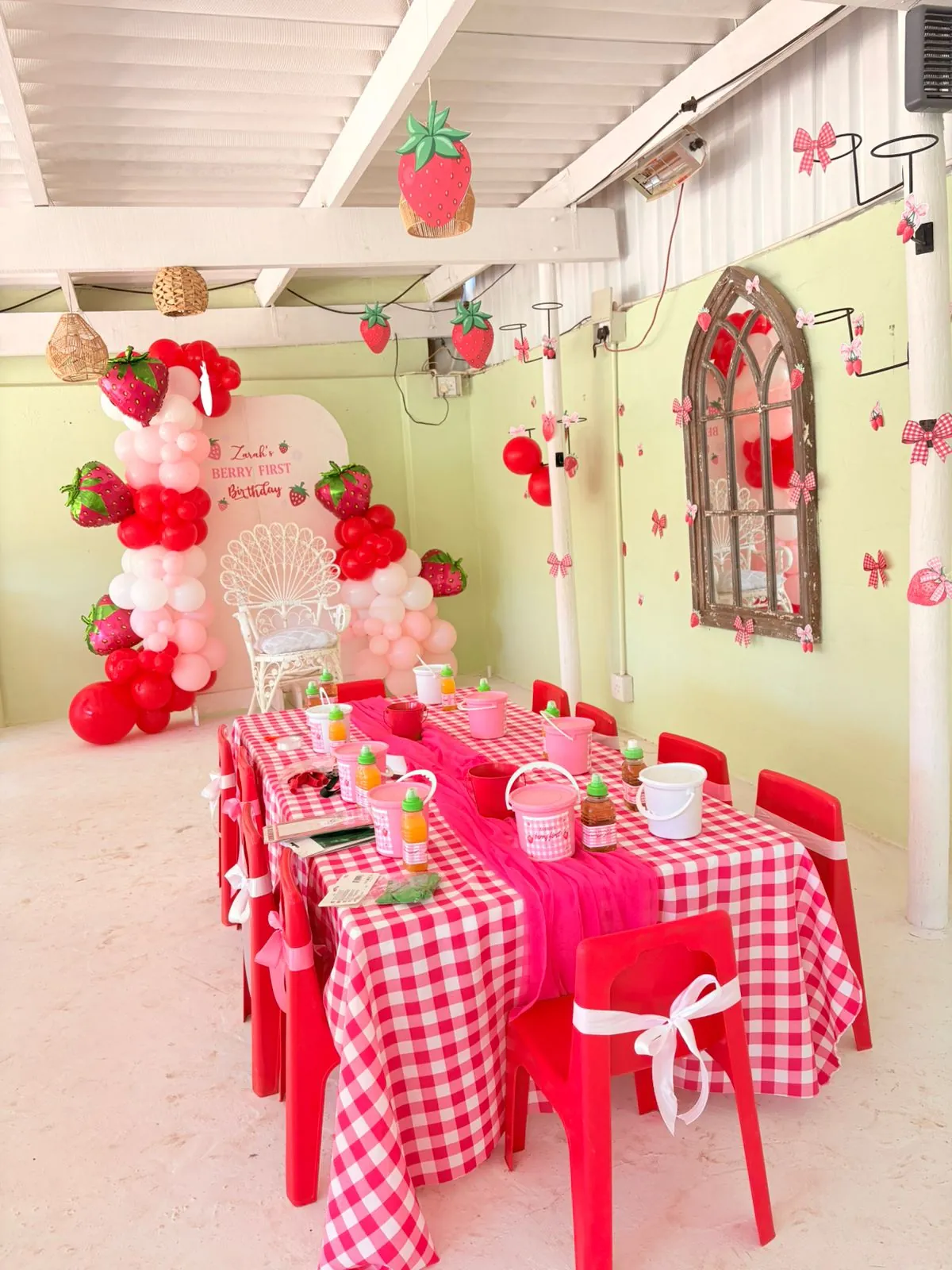 Kids party table with bright red styling and themed decorations