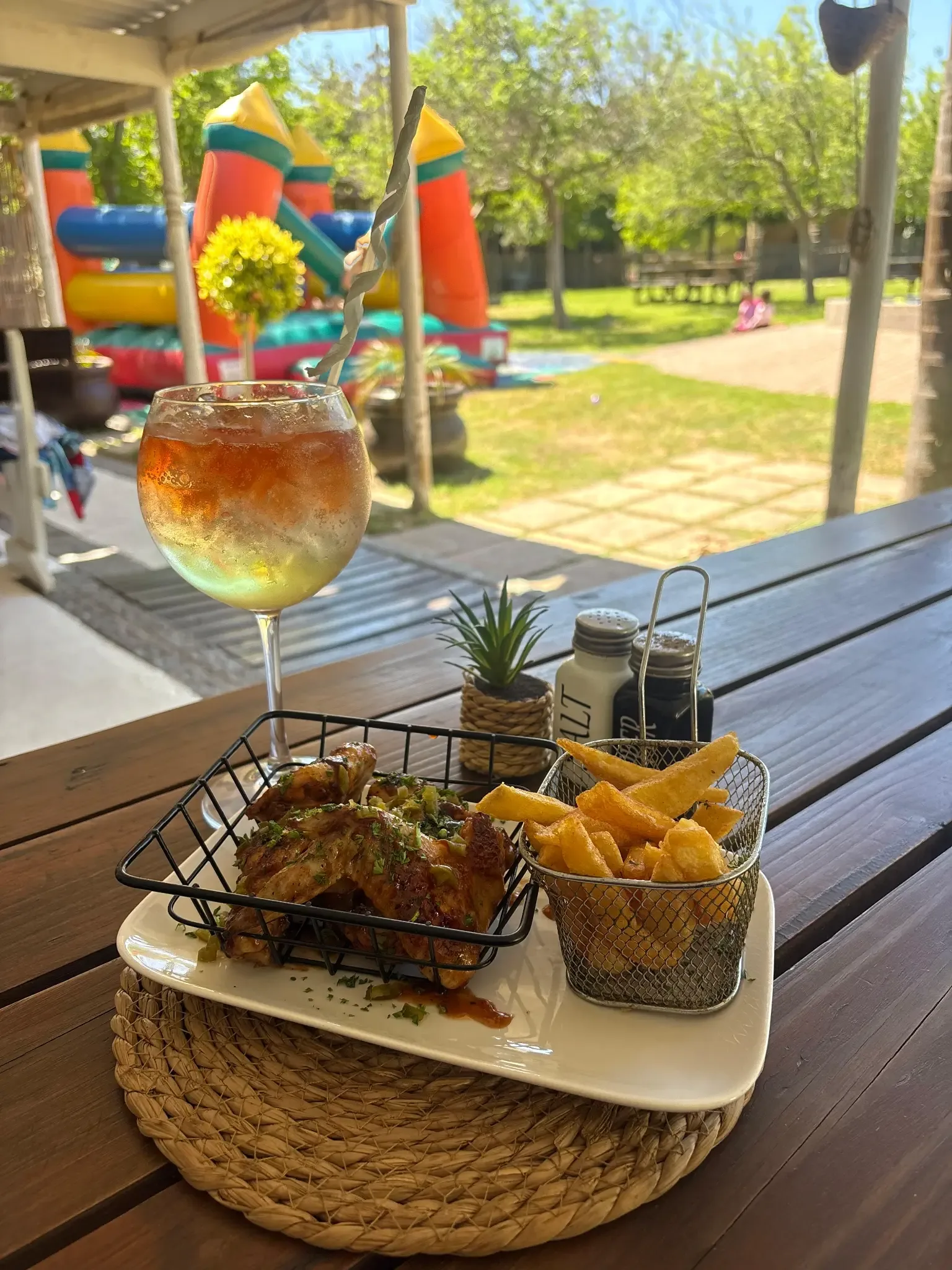 Chicken wings and chips served with a chilled drink at Olive & Vine